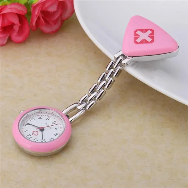 Dimensions: Total Length: Approximately 3.15 inches (8.0 cm). Case Diameter: Around 1.04 inches (2.64 cm). Case Thickness: Approximately 0.31 inches (0.79 cm). Dial Diameter: Around 20 mm. Materials: Case and Chain: Often made of metal, like zinc alloy or stainless steel. Mirror/Crystal: Commonly features a white glass mirror or Hardlex crystal window. Movement: Utilizes Quartz movement for accurate timekeeping. Design Features: Pin clip design for attachment to lapels or clothing. Water resistance for daily life activities like hand washing or rain, but not suitable for submersion. Triangular cross badge or similar design on the clip. Weight: Approximately 0.71 oz (20g).
