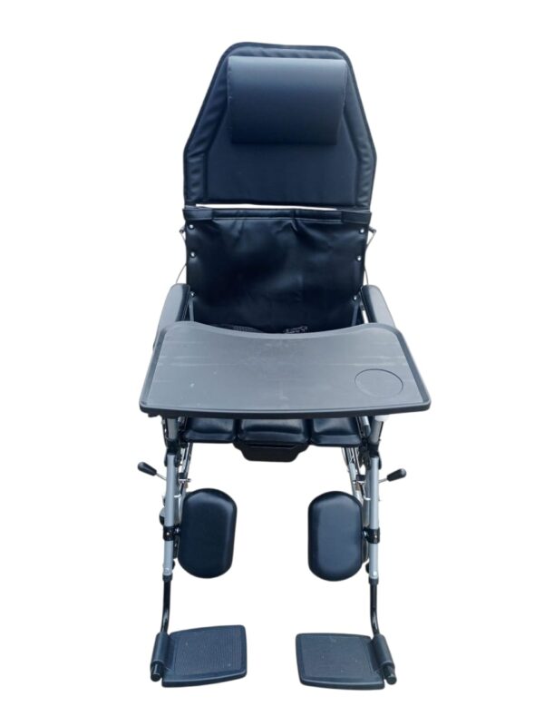 The wheelchair in the image is a high-back manual wheelchair, identified as a Wollex W213 or similar model, with several key features. Adjustable and Reclining Design: The wheelchair has a high backrest that can be reclined and a headrest for support. The footrests are also adjustable and can be raised. Removable Components: The armrests and footrests are detachable, which can make it easier for the user to transfer in and out of the chair. Tray: A removable tray is attached to the armrests, providing a surface for activities or meals. Braking System: The wheelchair includes a companion brake system, which allows an attendant to control the chair's speed and stop it. Durability and Portability: The frame is made of steel, and the wheelchair is foldable for easy storage and transportation.