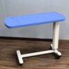 Adjustable plastic overbed table with wheels, tilting top, and dark wood finish. Ideal for eating, laptop use, and patient care. Easy height and angle adjustment—no tools required.